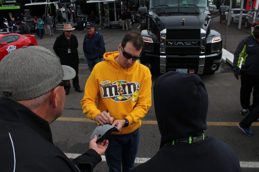 Kyle Busch signs autographs ahead of the 2018 Pocono 400. (Tyler Head | The Racing Experts)